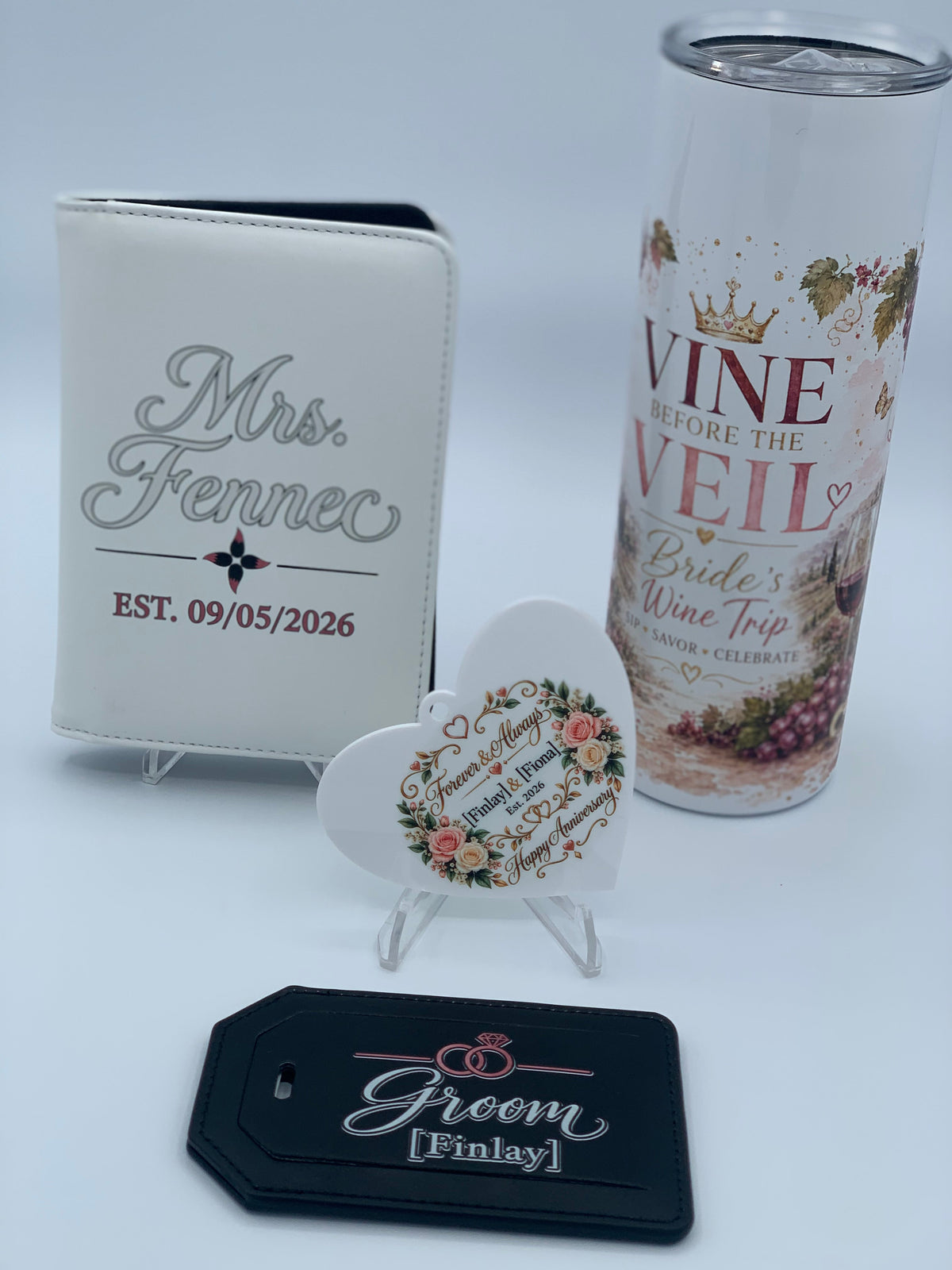 Personalized white and black leatherette luggage tags with wedding and groom designs by Fennec Creations.