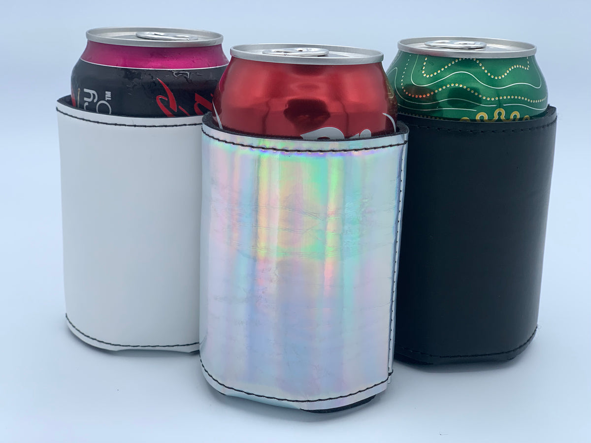 Assorted can coolers shown with beverage cans, including White, Holographic,and Black finishes.
