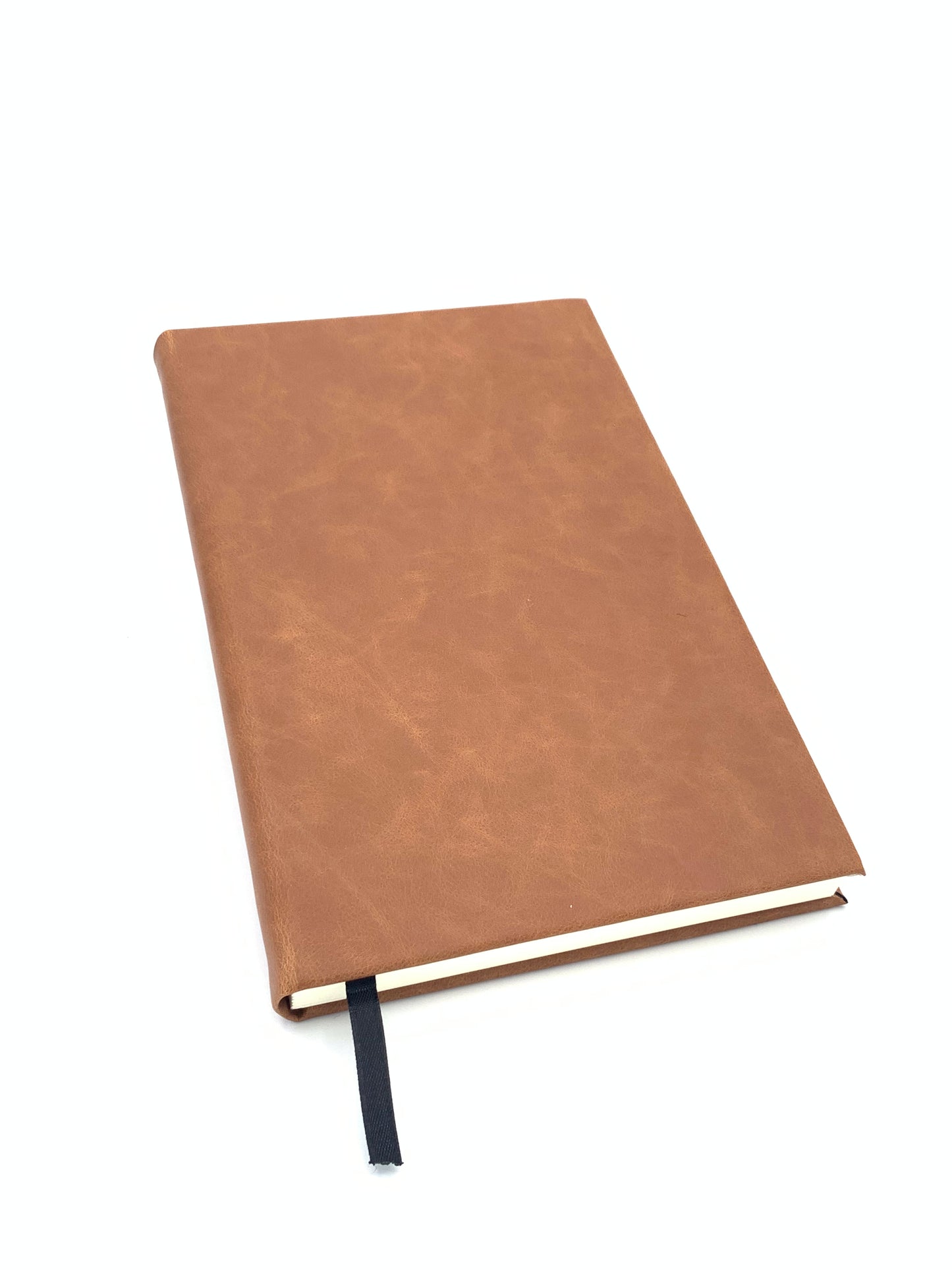 Angled view of the Rawhide leatherette journal showing the cover, binding, and attached ribbon bookmark.