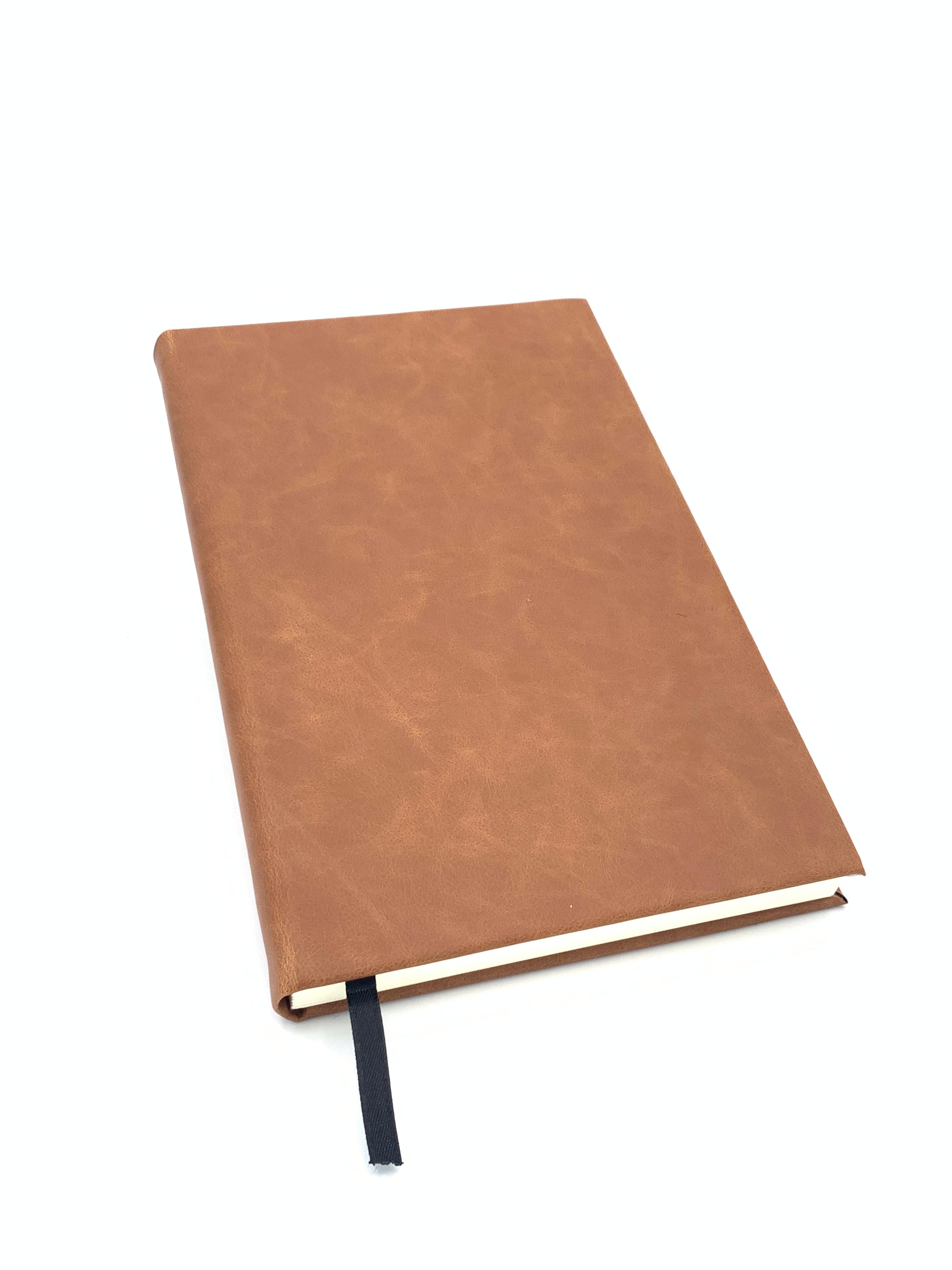 Angled view of the Rawhide leatherette journal showing the cover, binding, and attached ribbon bookmark.