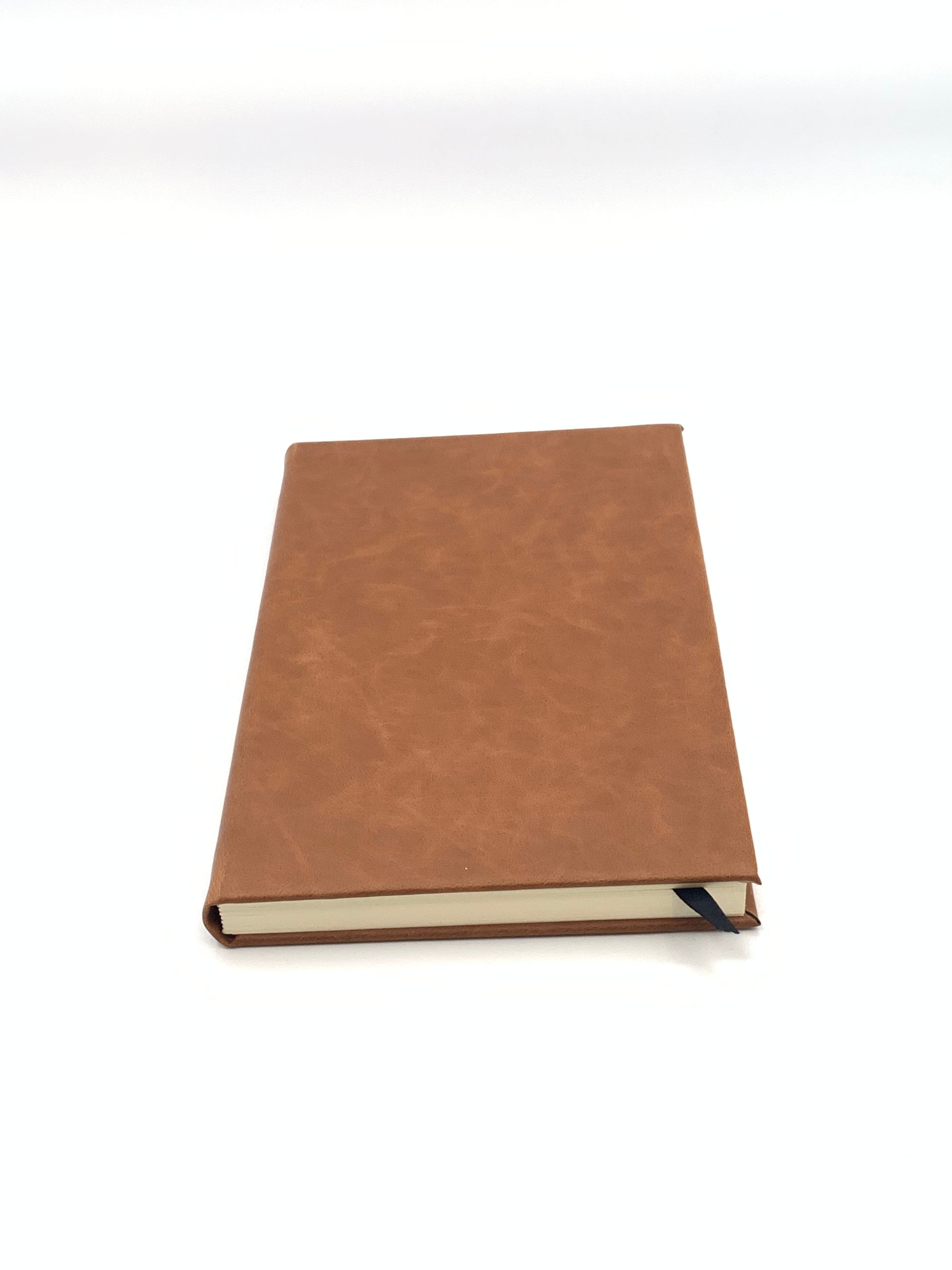 Closed Rawhide leatherette journal showing its compact profile and finished cover.