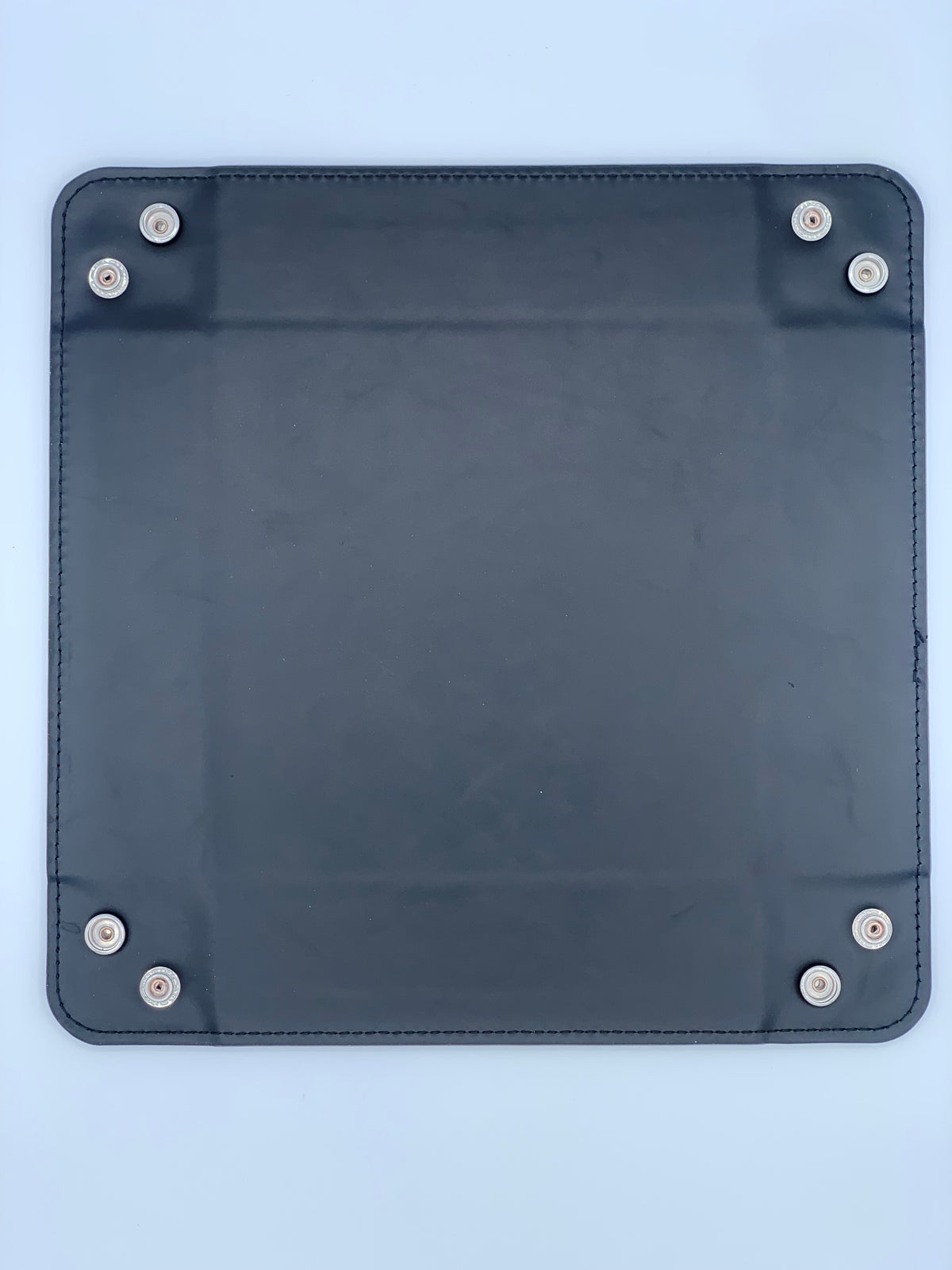 Leatherette valet tray shown laid flat with snap corners visible for easier storage, packing, and personalization.