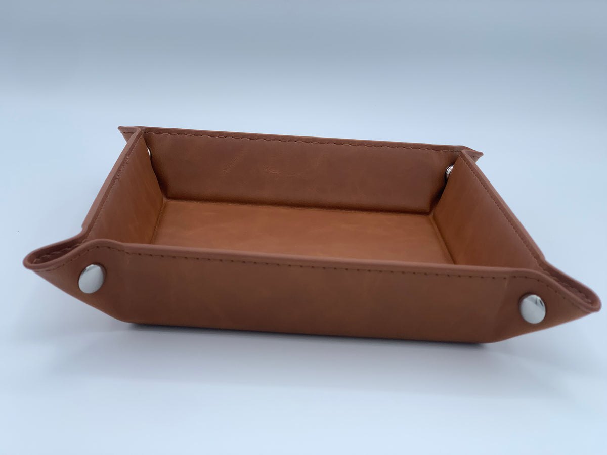 Angled view of the Rawhide leatherette valet tray showing the raised sides, snap corners, and finished shape.