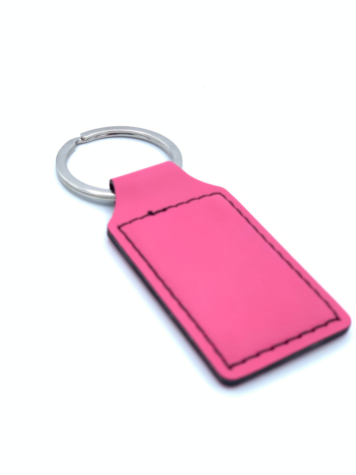 Primrose Pink leatherette keychain shown with attached metal key ring and stitched personalization area.