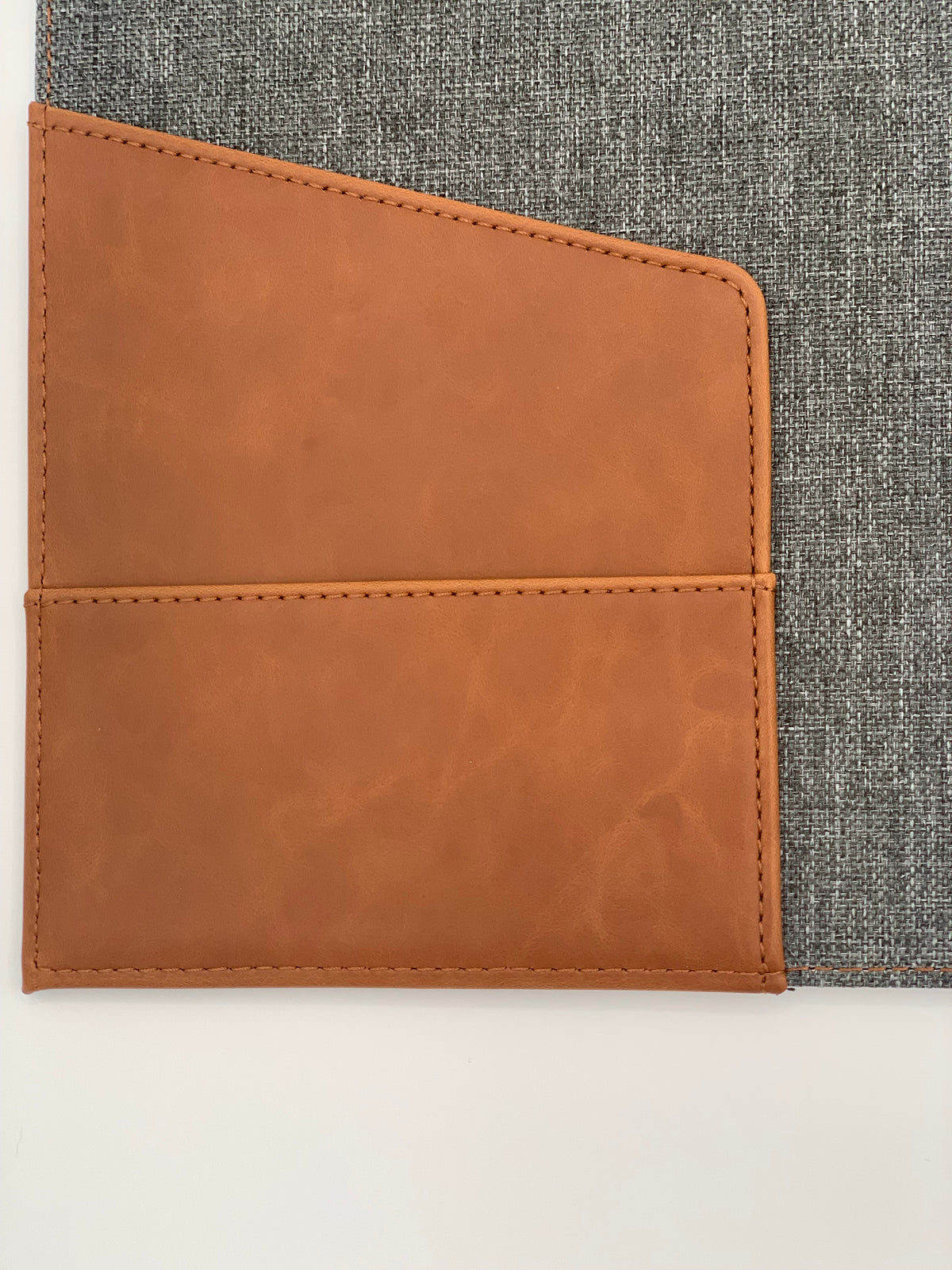 Close-up of the Rawhide/Gray padfolio showing the contrasting leatherette storage pocket and gray interior.