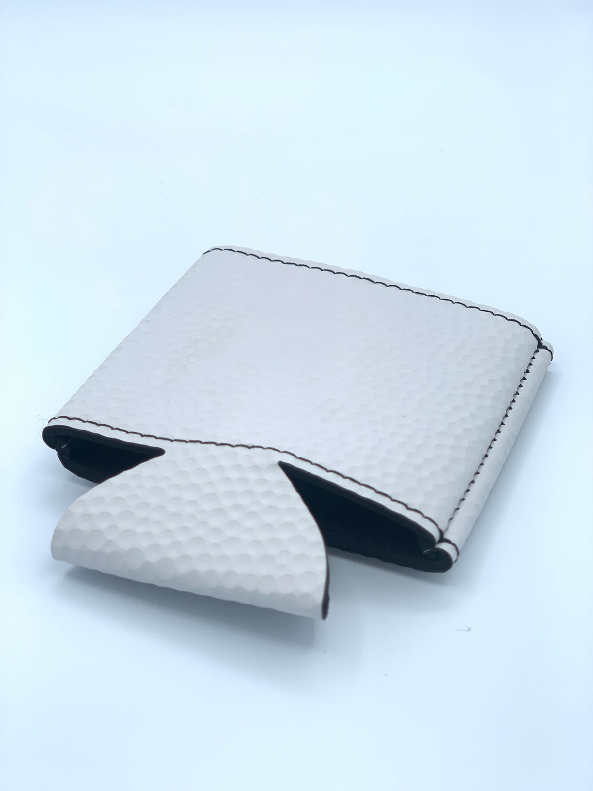 Front view of the Standard White Golf Ball Textured leatherette can cooler before personalization.