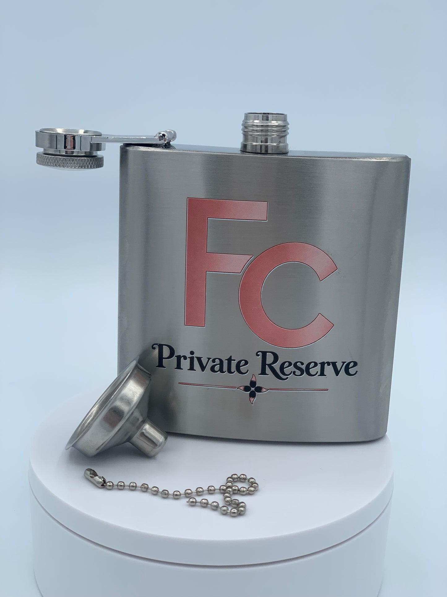 Custom printed stainless steel flask with FC Private Reserve artwork and chained funnel.