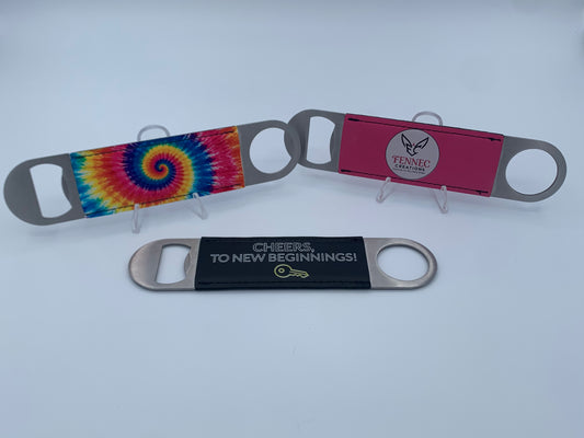 Personalized leatherette bar key bottle openers with custom UV-printed designs.