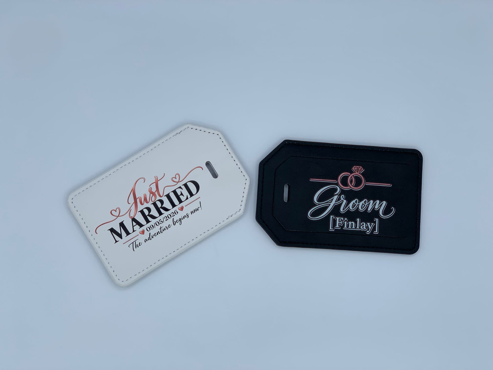 Personalized white and black leatherette luggage tags with wedding and groom designs by Fennec Creations.