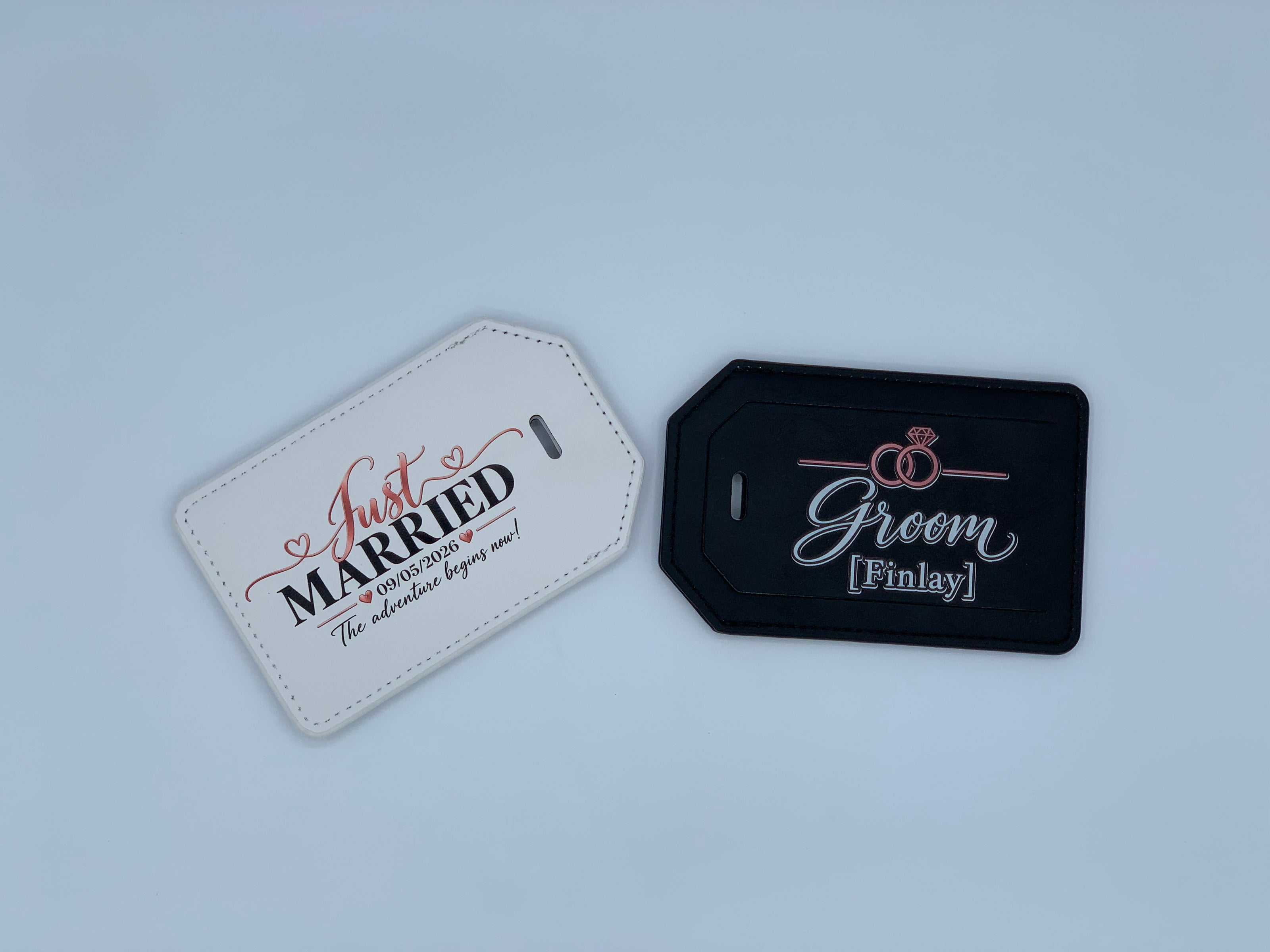 Personalized white and black leatherette luggage tags with wedding and groom designs by Fennec Creations.