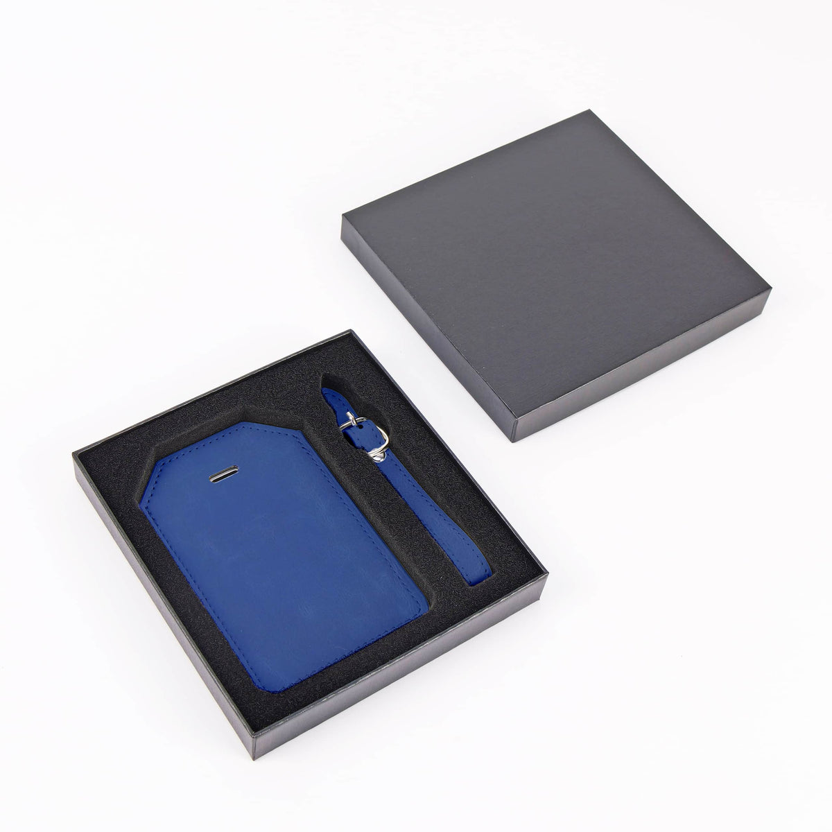 Navy Blue leatherette luggage tag with privacy flap and strap ready for personalization.