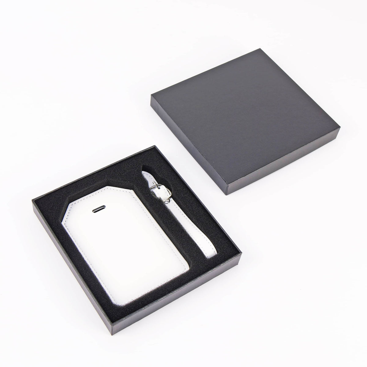 White leatherette luggage tag with privacy flap and strap ready for personalization.