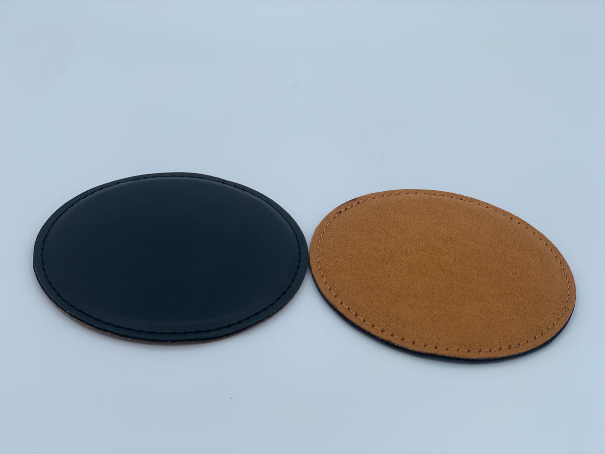 Round leatherette coasters shown in black and rawhide colored bottom